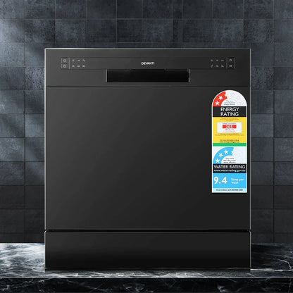 Black freestanding dishwasher with control panel and energy rating labels on tiled background
