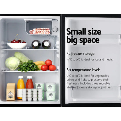 Compact refrigerator with food and drinks inside, open door showing storage features and freezer.