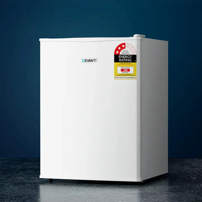 Compact white bar fridge with energy rating sticker, minimalist design, on dark background