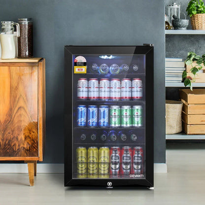 Black glass door bar fridge filled with assorted beverage cans in a modern kitchen setting