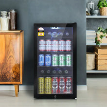 Glass door bar fridge filled with assorted beer and soda cans in modern kitchen setting