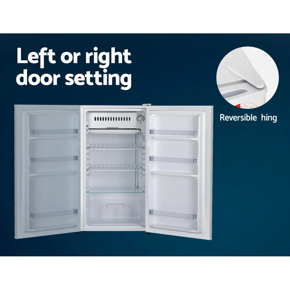 White upright refrigerator with reversible door hinge, adjustable shelves, and dual door setting.