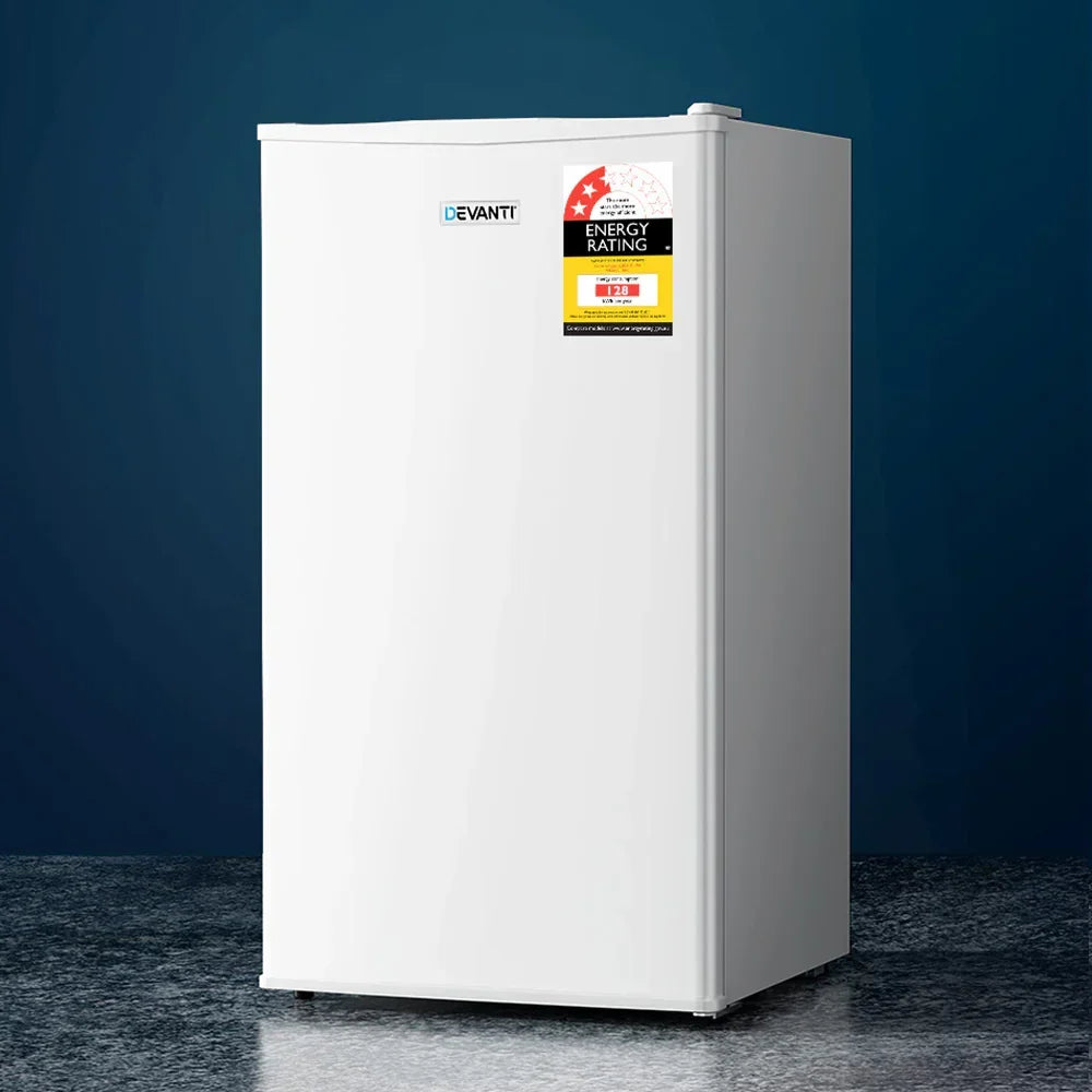 White single-door compact fridge with energy rating sticker on reflective surface