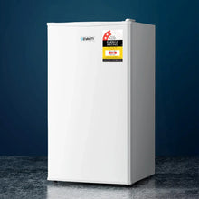 White single-door compact fridge with energy rating sticker on reflective surface