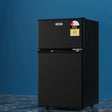 Black two-door compact refrigerator with freezer, energy rating label, on blue background