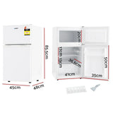 White compact bar fridge with freezer, doors open showing interior shelves, labelled dimensions.
