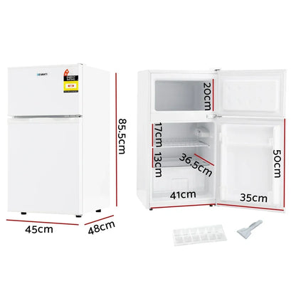 White compact bar fridge with freezer, doors open showing interior shelves, labelled dimensions.