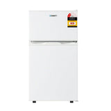 White compact double-door refrigerator with energy rating sticker on the top freezer.