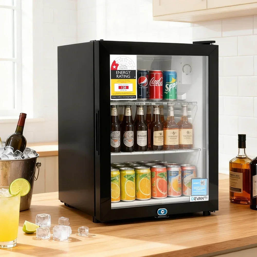 Black glass door bar fridge stocked with drinks on a kitchen bench, energy rating label visible