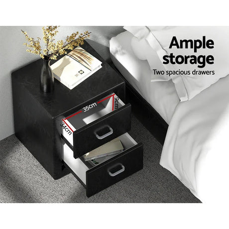 Black bedside table with two spacious drawers, vase, books, and storage dimensions shown.