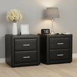 Pair of modern black bedside tables with two drawers, lamp, clock, flowers, and decor