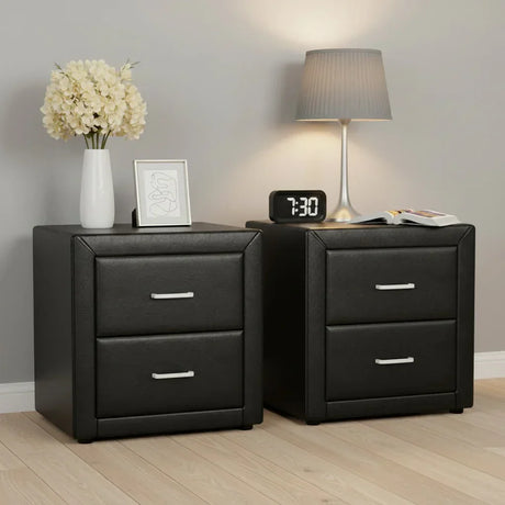 Pair of modern black bedside tables with two drawers, lamp, clock, flowers, and decor