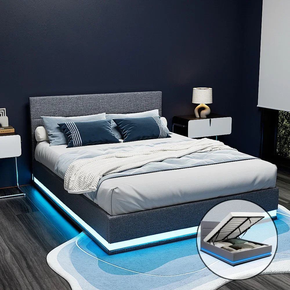 Modern grey upholstered bed frame with LED lighting and gas lift storage in a stylish bedroom.