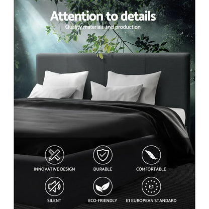 Modern dark upholstered bed with white pillows and blanket, quality icons and forest backdrop