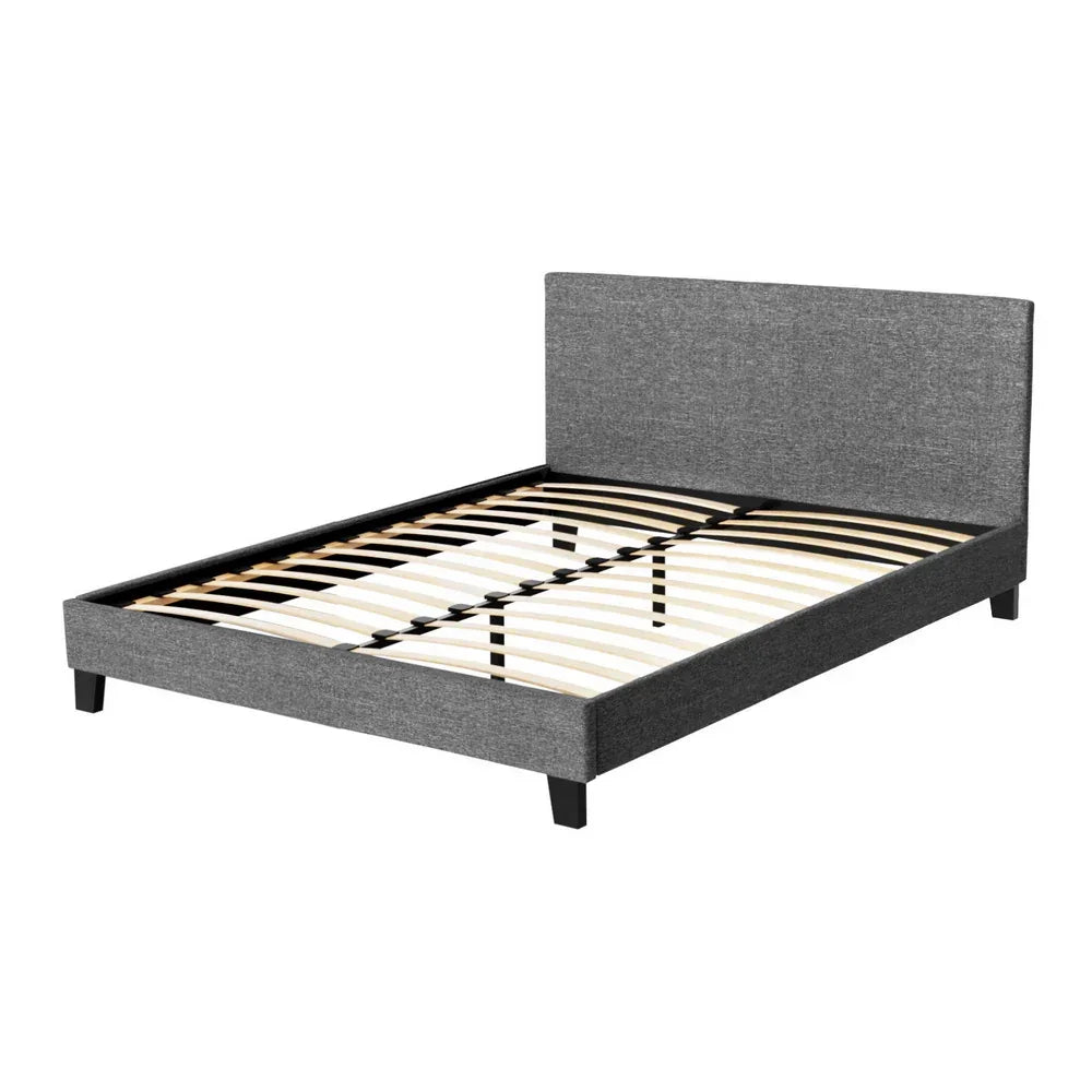 Modern grey upholstered bed frame with headboard and wooden slats on white background