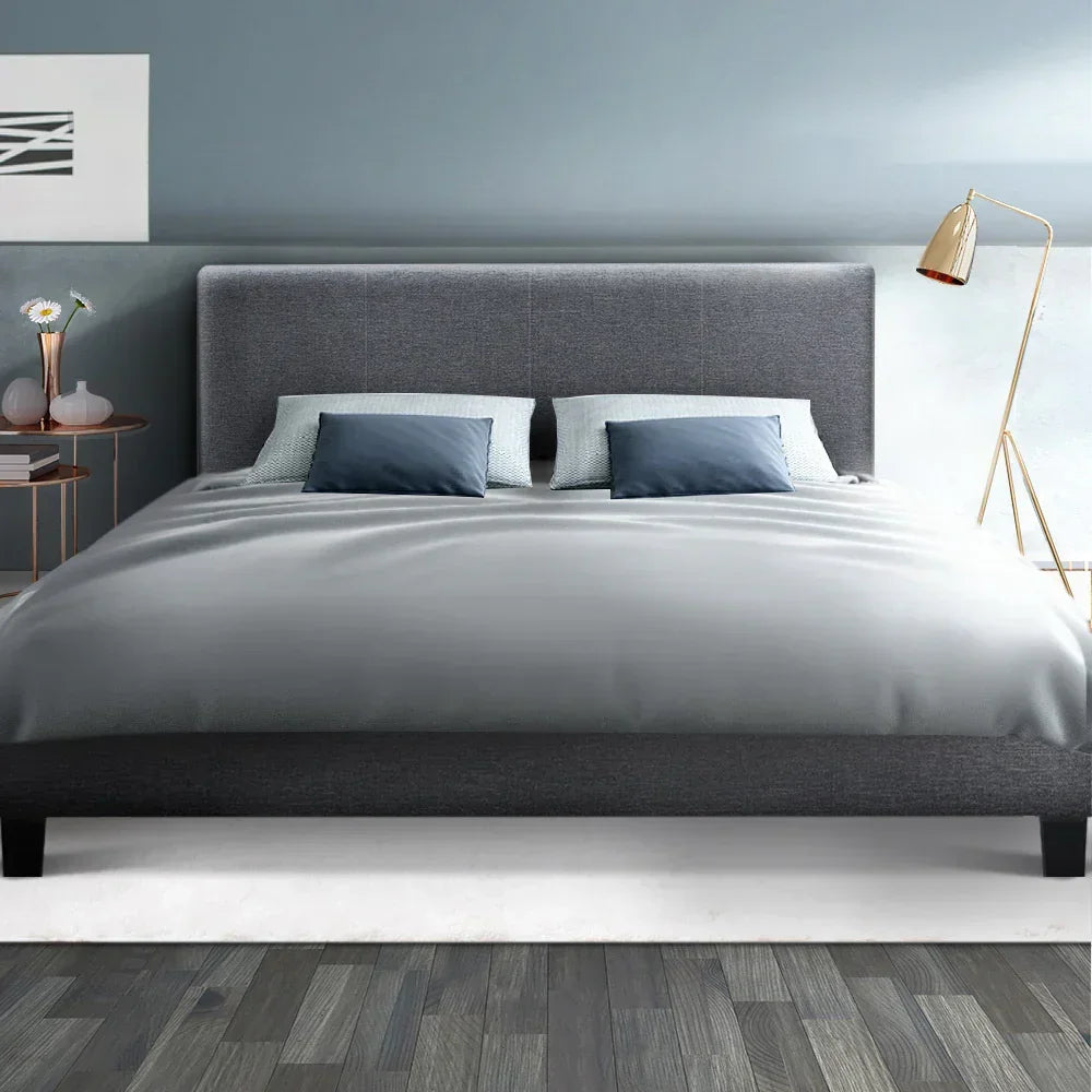 Modern queen grey fabric bed frame with headboard, pillows, and minimalist bedroom decor
