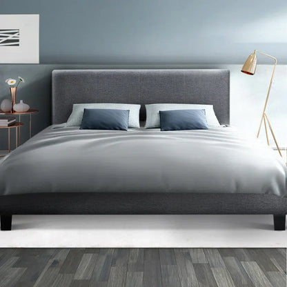 Modern queen grey fabric bed frame with headboard, pillows, and minimalist bedroom decor