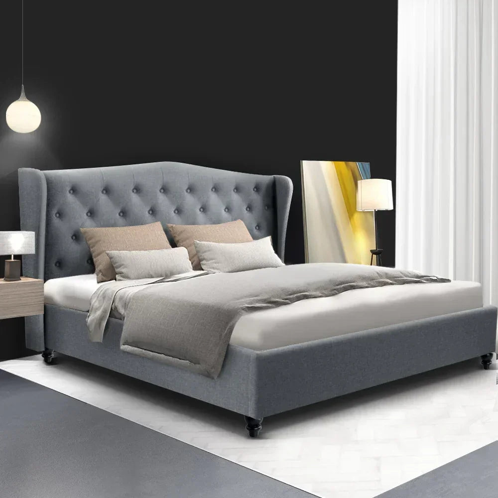 Modern grey upholstered bed frame with wingback headboard in stylish bedroom setting