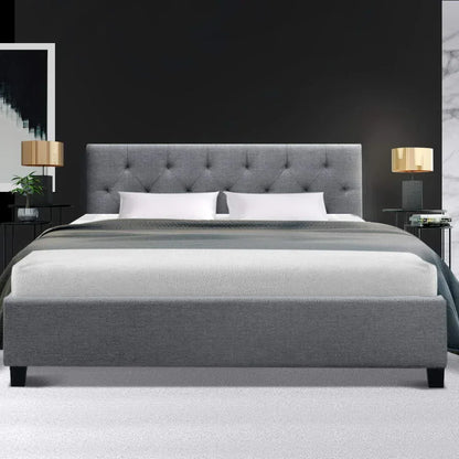 Modern grey upholstered bed frame with tufted headboard in stylish bedroom setting