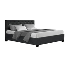 Modern charcoal upholstered bed frame with tufted headboard and bedding, isolated on white