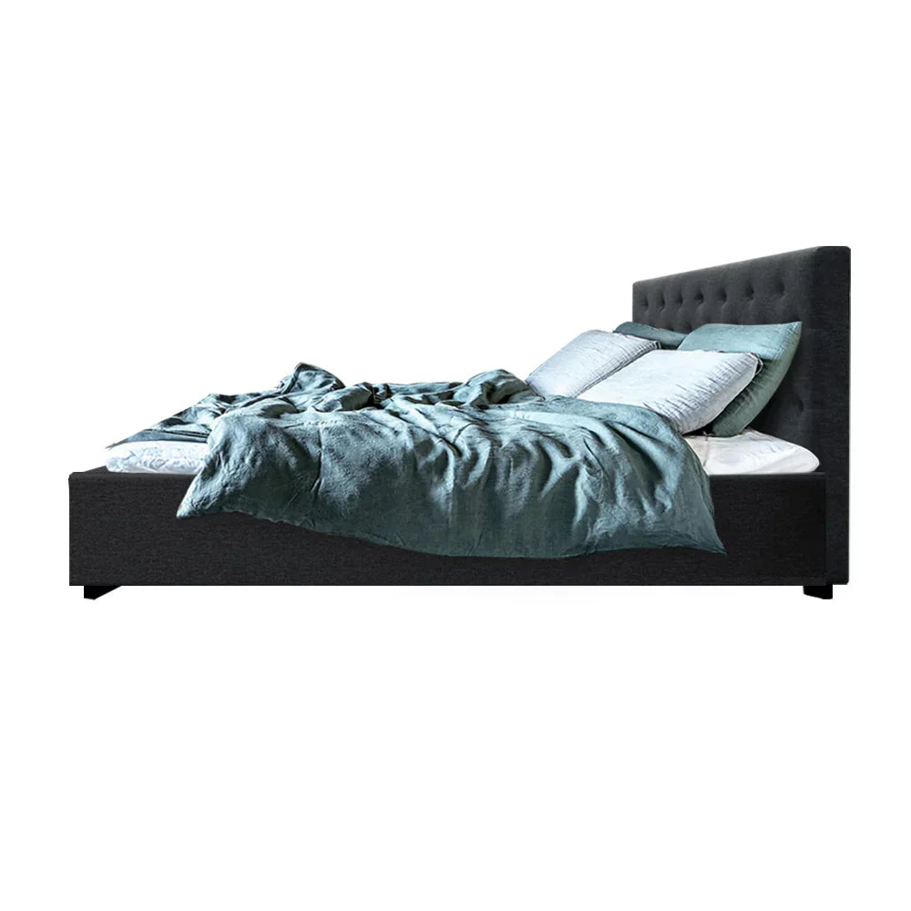 Modern charcoal fabric bed frame with tufted headboard, teal bedding, and multiple pillows