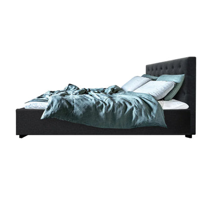 Modern charcoal fabric bed frame with tufted headboard, teal bedding, and multiple pillows