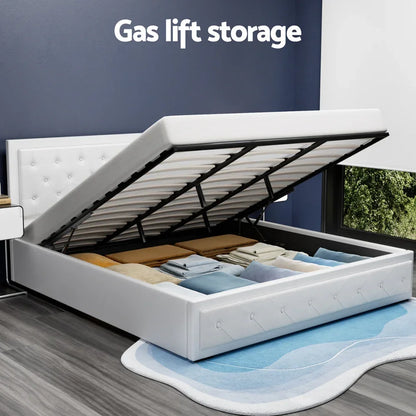 White upholstered gas lift storage bed with open frame revealing underbed storage space in modern bedroom.