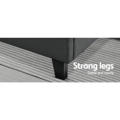 Sturdy black sofa leg on textured grey carpet, highlighting strong, stable furniture support.