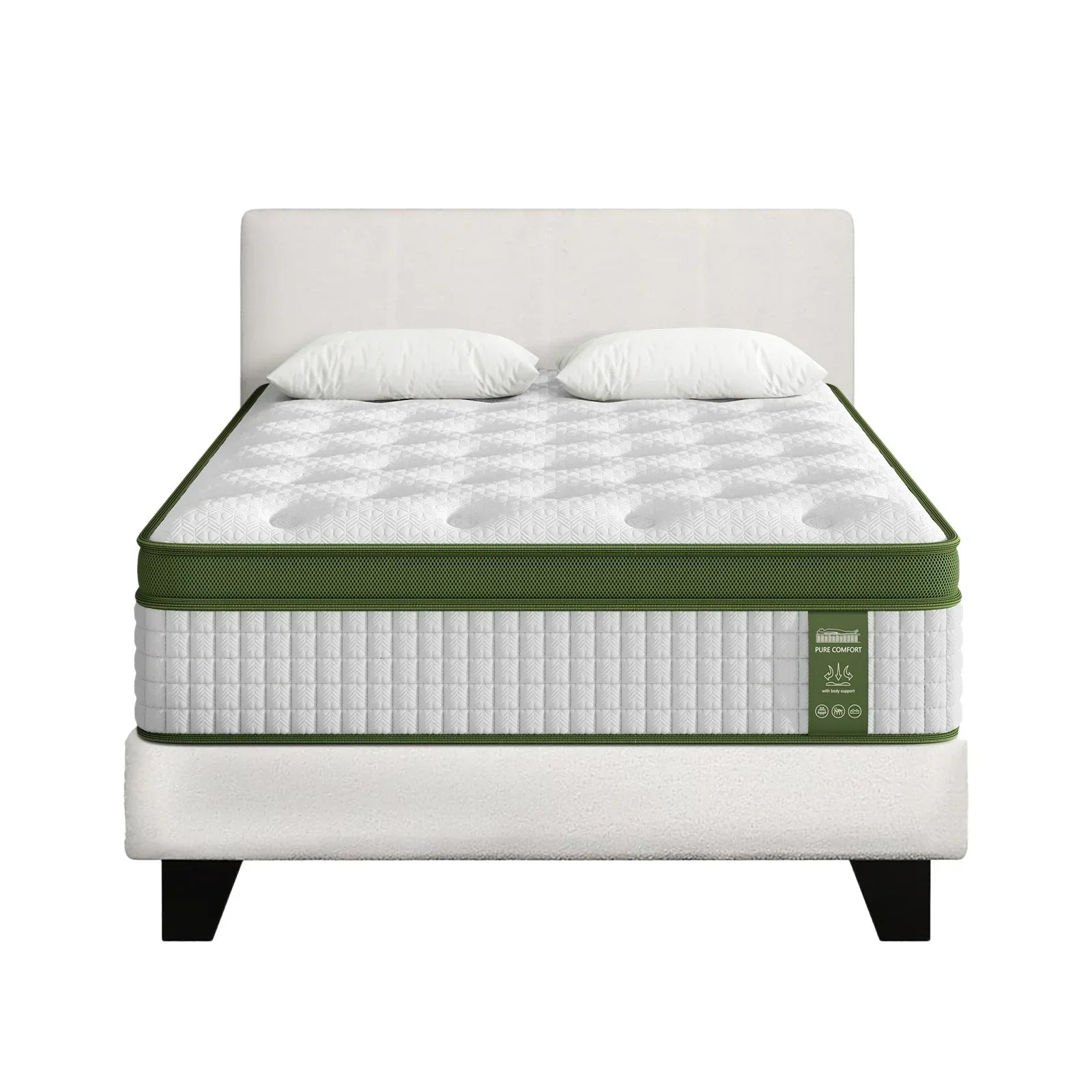 White bed with padded headboard, two pillows, and thick green-trimmed mattress