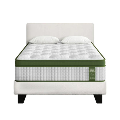 Queen size mattress with white and green design on a bed frame, two pillows on top