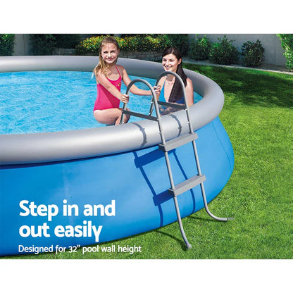 Inflatable above ground pool with metal ladder, two people entering pool, green lawn background