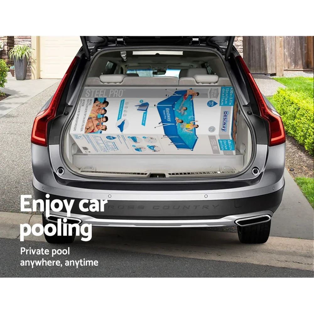 Large rectangular above-ground pool box shown in open SUV trunk in suburban driveway