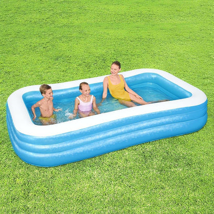 Rectangular inflatable pool with two children and an adult relaxing outdoors on grass