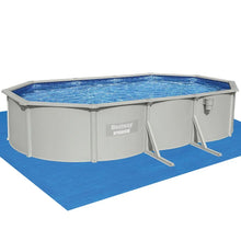 Above ground oval swimming pool with metal frame and clear blue water on blue mat