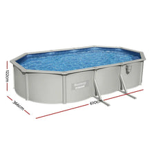 Large oval above ground pool with steel frame, blue water, and visible dimensions 610x366x122cm
