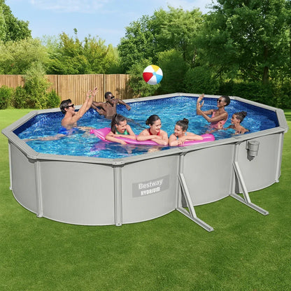 People playing in an above ground Bestway Hydrium pool with a beach ball in a backyard