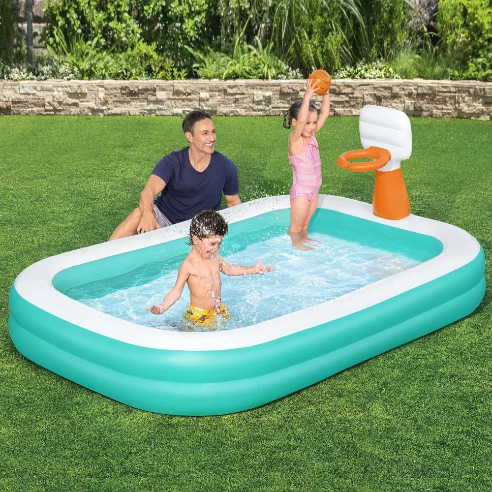 Kids and adult playing in rectangular inflatable pool with basketball hoop outdoors