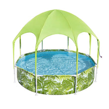 Round outdoor swimming pool with tropical leaf print and green canopy shade cover