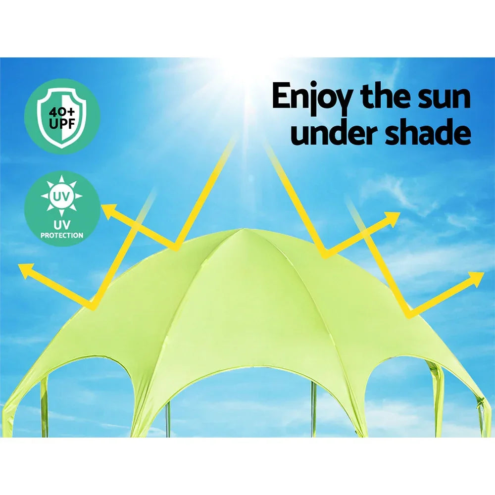 Green outdoor canopy with UPF 40+ UV protection under sunny blue sky