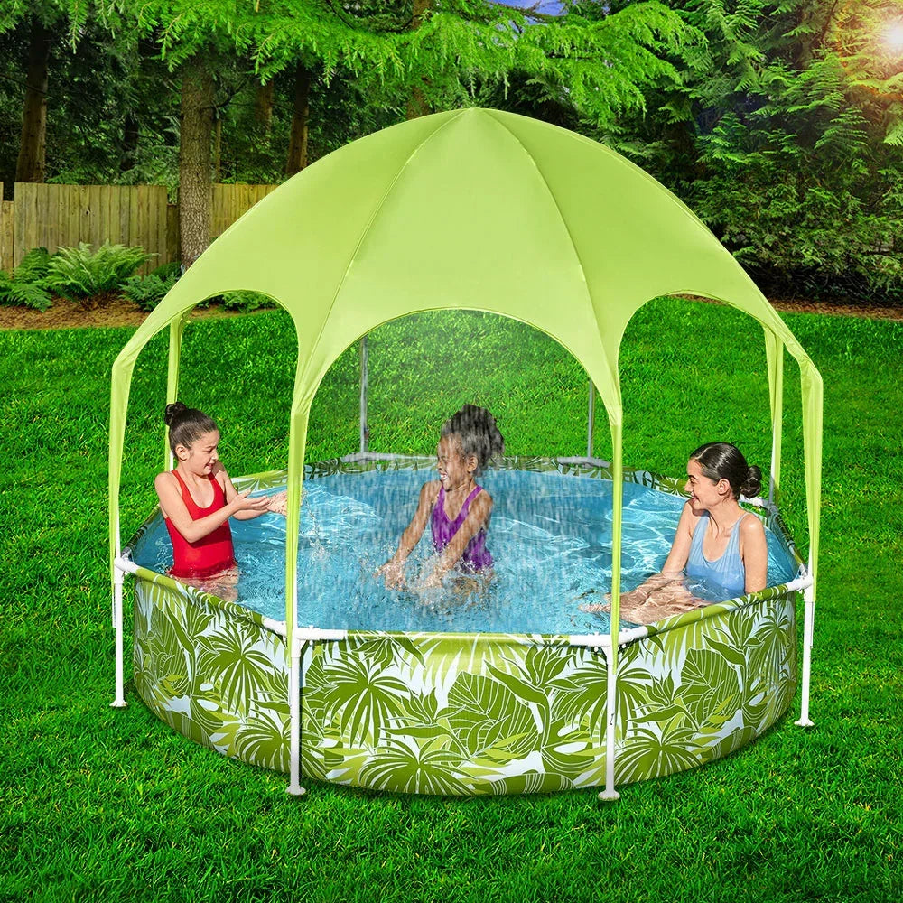 Outdoor kiddie pool with canopy and sprinkler, two children and an adult playing in the water