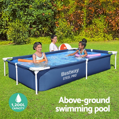 Rectangular above-ground swimming pool with kids playing on a grassy backyard.