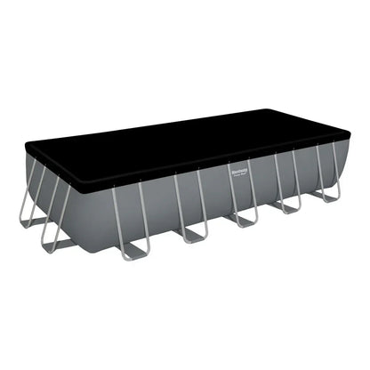 Rectangular above ground pool with black pool cover and metal frame