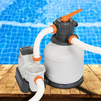Pool sand filter pump system on wooden deck by a clear blue swimming pool