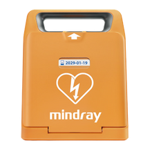 Orange portable defibrillator case with heart and lightning symbol, handle on top, and expiration date label.