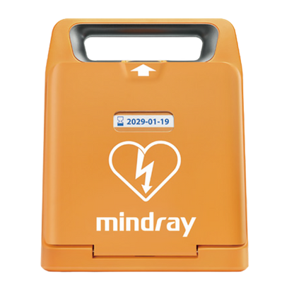 Orange portable defibrillator case with heart and lightning symbol, handle on top, and expiration date label.