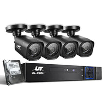 Four black security cameras with UL-TECH DVR and hard drive, surveillance camera system
