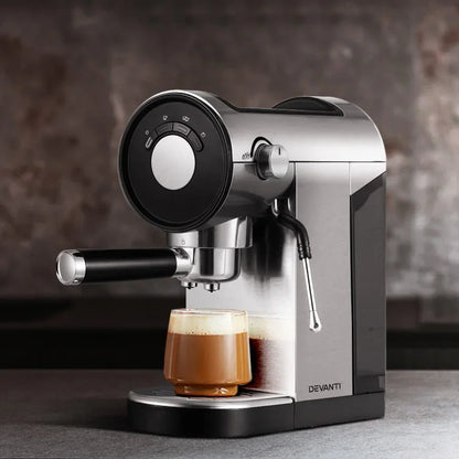 Stainless steel espresso coffee machine brewing a cappuccino in a glass cup