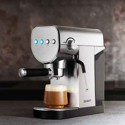 Stainless steel espresso coffee machine brewing a cappuccino in a clear glass cup