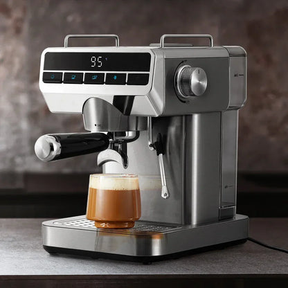 Stainless steel espresso machine brewing coffee into a glass cup on a kitchen counter