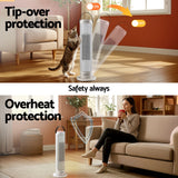 White tower heater with tip-over and overheat protection features shown in living room setting.